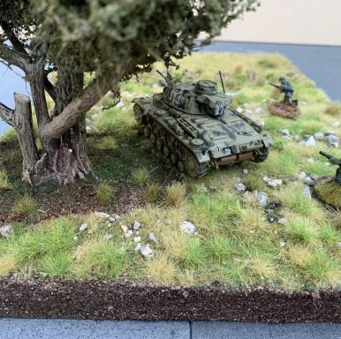 Handcrafted Woodland Terrain for 20–28mm Games Military diorama featuring a tank, soldiers, and a tree on a grassy terrain.
